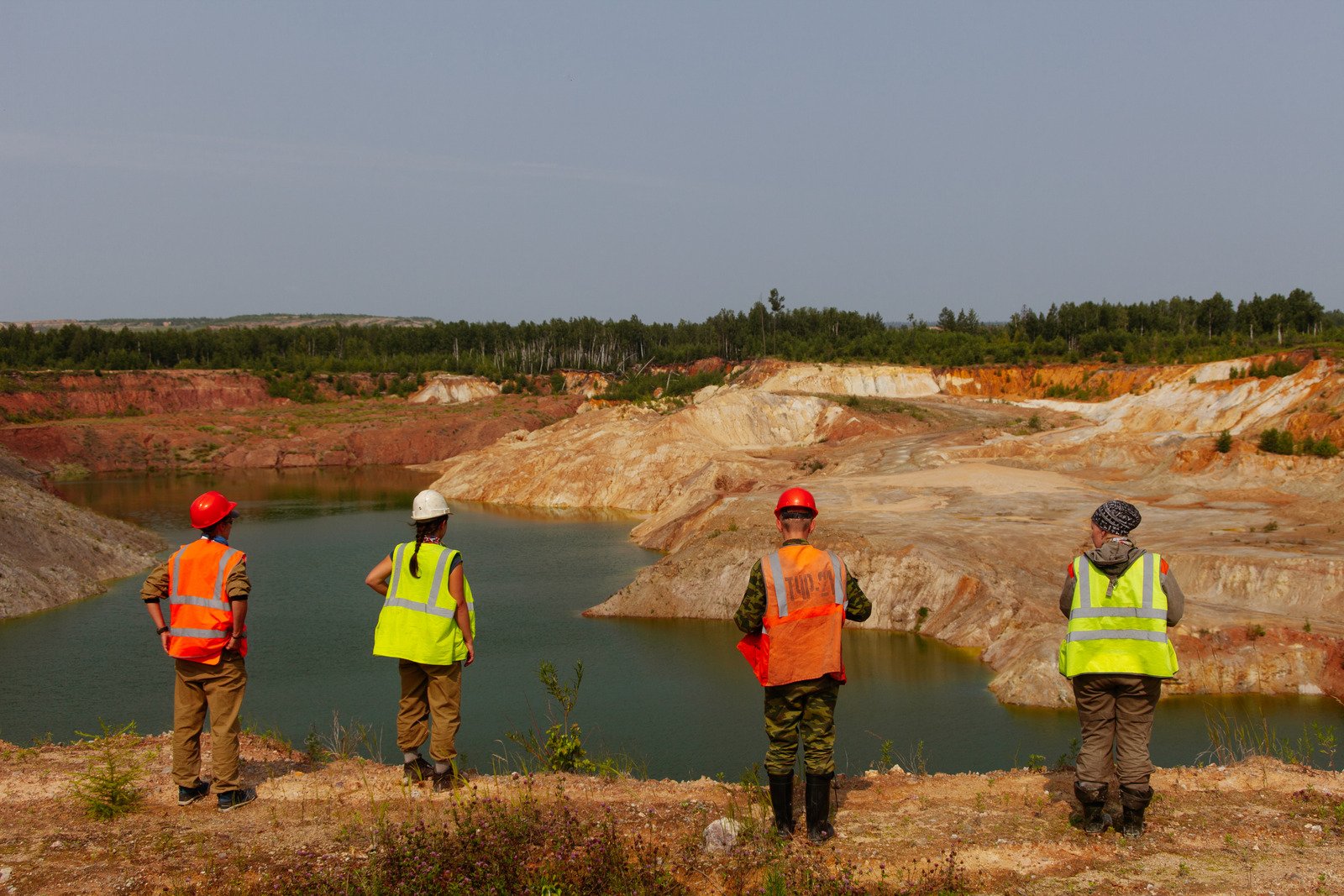 -workers-standing-near-lake