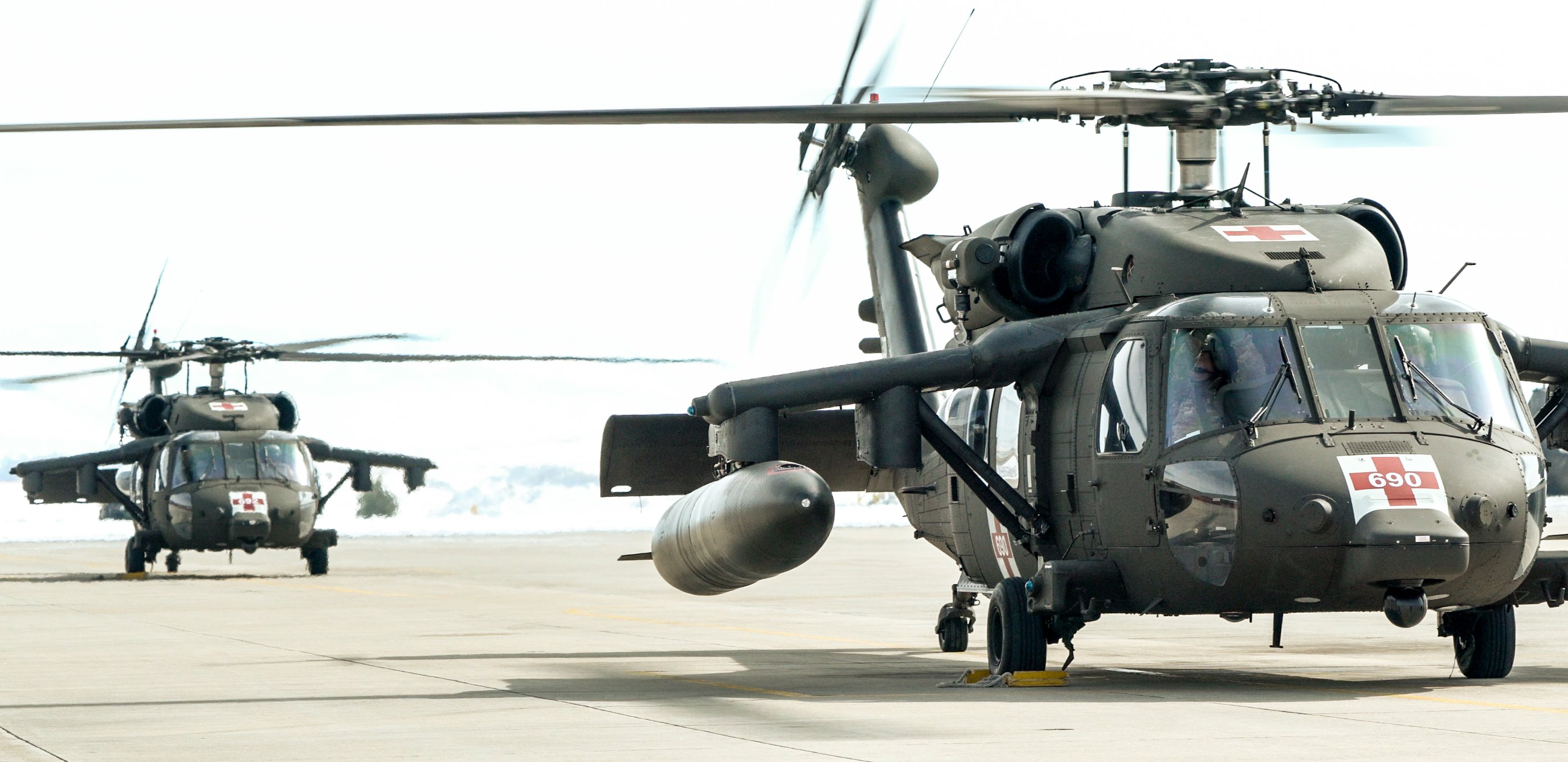 Two Blackhawk helicopters on the tarmac for simulation training